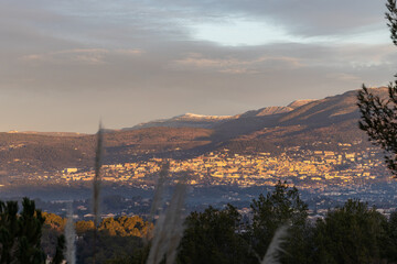 Sunrise over the city of Grasse with snow covered mountains, , Côte d'Azur, Provence, France