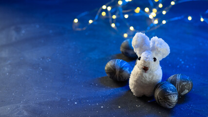 easter bunny with eggs on dark blue background with bokeh garland