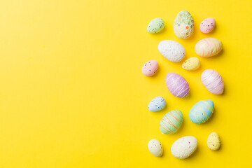 Obraz na płótnie Canvas Happy Easter concept. Preparation for holiday. Easter eggs on colored background. flat lay top view copy space banner