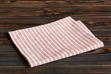 top view with red empty kitchen napkin isolated on table background. Folded cloth for mockup with copy space, Flat lay. Minimal style