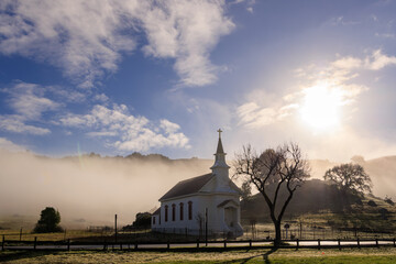 Historic small town church in West Marin County in fog and morning sun