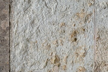 Weathered and aged concrete wall with paint smeared off it