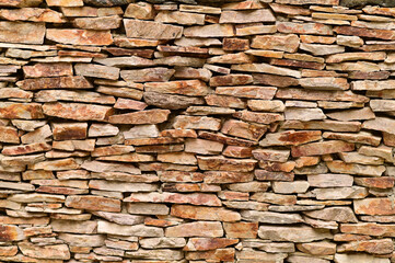 stones of indeterminate shape made of ginger stone are a mosaic on the wall