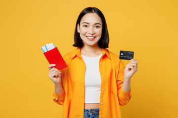 Young woman in summer casual clothes use mobile cell phone hold credit card isolated on plain...