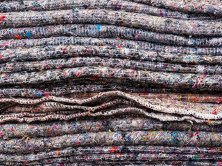 Heavy duty wool mix fabric blankets. Stacked, for furniture protection, house removal, packing material and storage. Close up view.