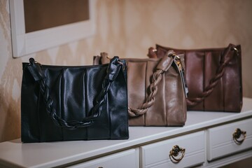 Elegant leather bags on top of a white table