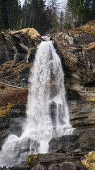 Small waterfall going down sharp stone cliffs