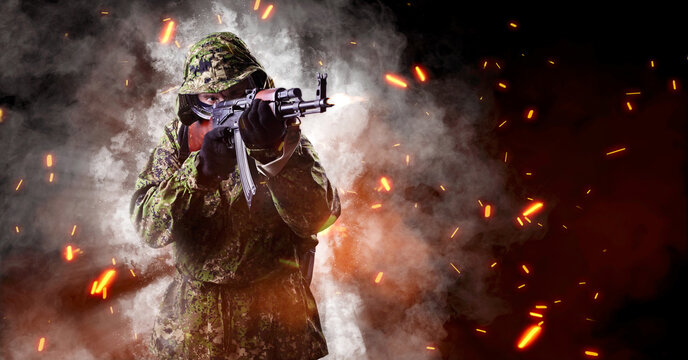 An armed soldier in military uniform aims with a rifle. One. Smoke, sparks, poster