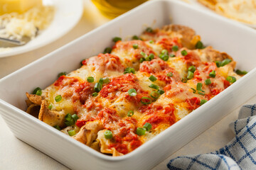 Baked pancakes with chicken in tomato sauce.