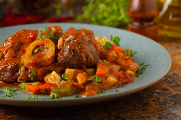 Ossobuco served with stewed vegetables.