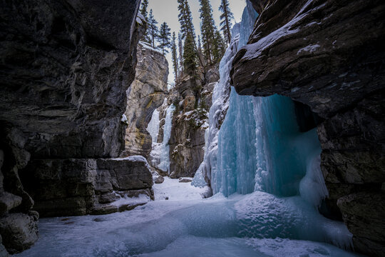inside view of frozen river of maligne canyon in jasper national park with curved shpaes of rocks