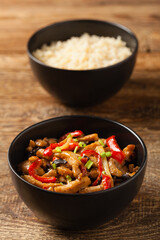 Pork chop with peppers, mushrooms and bamboo. Served with rice.