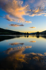 Fototapeta na wymiar Clouds reflecting off of Nottingham Lake at sunset in Avon, Colorado, USA