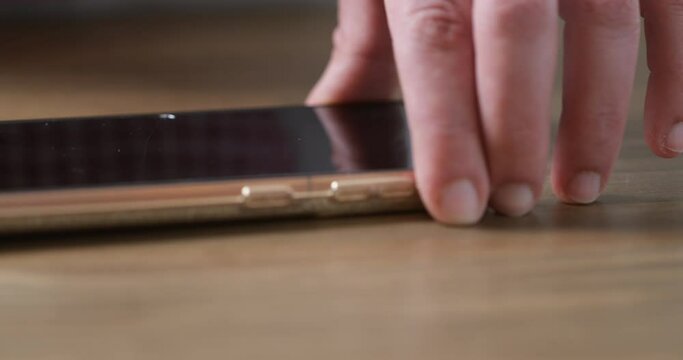 Keeping connected in the kitchen: A woman charging her phone while preparing a meal