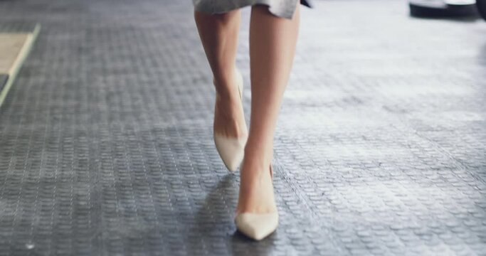Shoes of business woman walking, arriving or leaving work alone in an office at work. Shoes and feet of a corporate professional, manager or confident employee entering a workplace or startup company