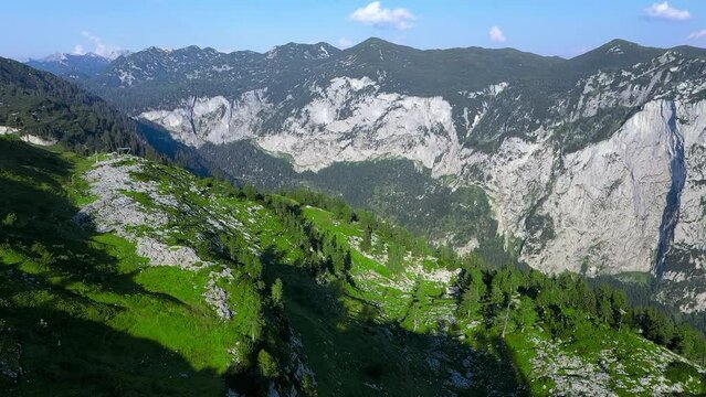 Scenic aerial view of evergreen mountains against a blue sky during daytime