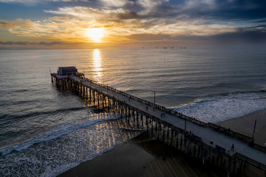 Drone shot of a metallic pier of the sea at sunset, cool for background