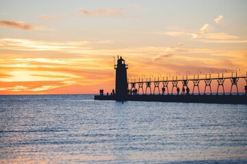 Mesmerizing view of a lighthouse overlooking a beautiful seascape at scenic sunset