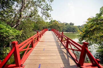 Fototapeta na wymiar Beautiful view of green trees in the Huc Bridge in Hanoi Vietnam