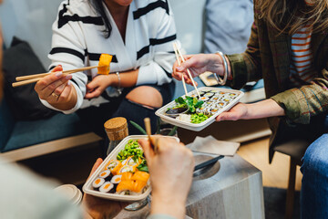 People having lunch, group of friends having sushi, eating asian food. © Aleksandrs Muiznieks