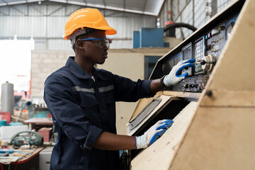 Factory male worker at work in the industry factory, work with CNC machine. Factory engineer male...