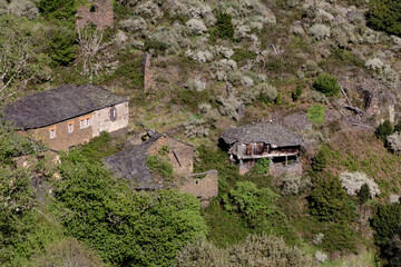 "Bojo", abandoned village in the council of Allande with buildings with slate roofs, surrounded by a protected cork oak grove