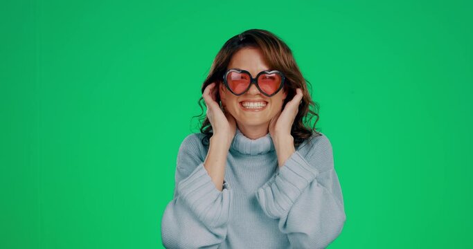 Silly woman portrait, green screen and sunglasses of a young female with happiness in a studio. Isolated, smiling model and joy of a person feeling comic, funny and cheerful with excitement and humor