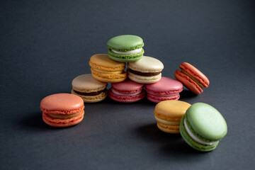 A macaroon is a French pastry made with egg whites, sugar, and ground almonds. Sweet French macaroons on a dark background.