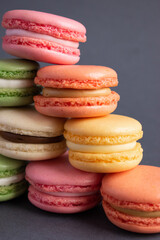 A macaroon is a French pastry made with egg whites, sugar, and ground almonds. Sweet French macaroons on a dark background.
