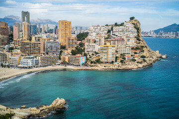 Benidorm tourist town. apartment buildings, hotels on La Cala de Finestrat. Panorama of the densely built-up city with mountains in the background