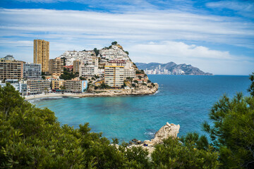 Benidorm tourist town. apartment buildings, hotels on La Cala de Finestrat. Panorama of the densely built-up city with mountains in the background