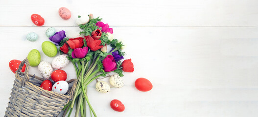 Naklejka na ściany i meble Poppy flower and Easter eggs in a wicker basket, white wooden table