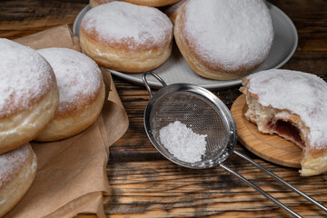 Pączki deep-fried Polish doughnuts and mini strainer with powdered sugar. Celebrating Fat...