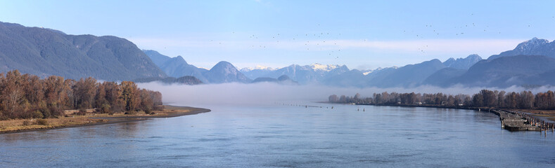 Tranquil river rolling through mountain valley 