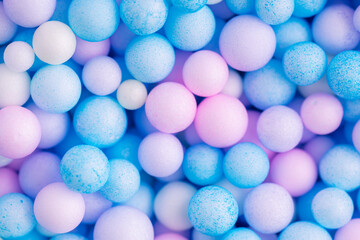 Colorful balls background in pink and blue colors. Background with colorful balls in different sizes. Sphere of balls on pastel color.