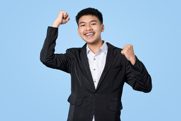 Young handsome asian businessman excited celebrating success isolated on blue light background