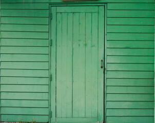 Wooden green door with wall, texture and background.