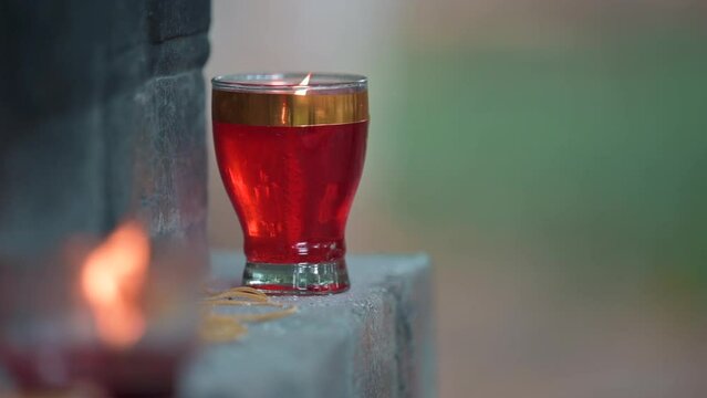 Closeup of a prayer candle burning on a stone