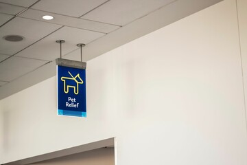 Low angle shot of a blue pet relief sign inside an airport