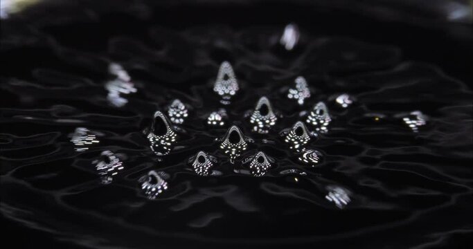 Magnetic fluid. Ferrofluid. Black liquid surface. Abstract background. Natural phenomenon of magnetism ferro fluidic substances under the action of a neodymium magnet can create really impressive.
