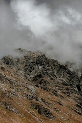 Vertical aerial landscape of the rocky hill San Bernardino covered in dark clouds