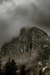 Vertical aerial landscape of the rocky hill San Bernardino covered in dark clouds