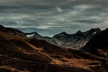 Fototapeta na wymiar Mesmerizing landscape of the rocky mountains on a dark cloudy day