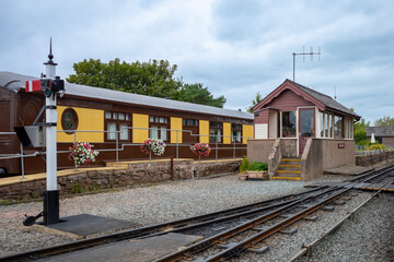 Old English railway station with guard house, carriage and signal