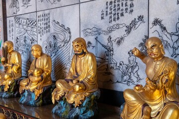 Golden statuettes of the Korean Gods on the table