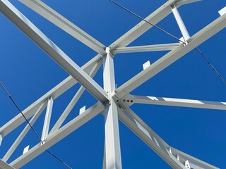 Fototapeta premium Closeup shot of steel columns and beams on a construction site under a blue sky