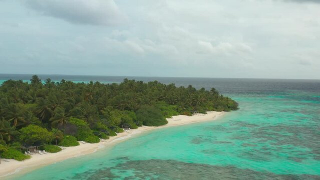 Aerial view a Tropical beach with palm trees, Thinadhoo island, Vaavu atoll, Maldives.