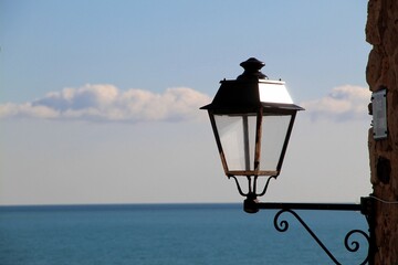 Beautiful shot of a garden lantern with a sea in the background