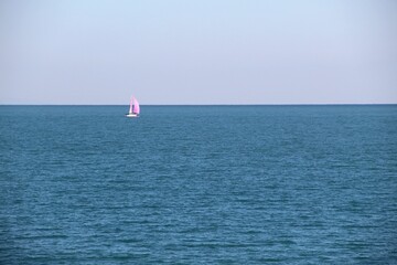 Beautiful shot of a pink sailing boat in a sea