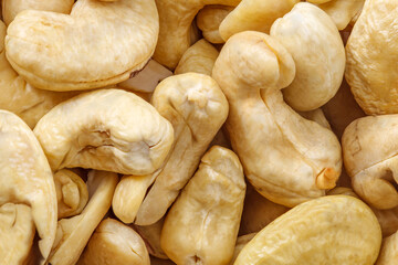 Cashew nuts lot of peeled fried piled in pile close-up